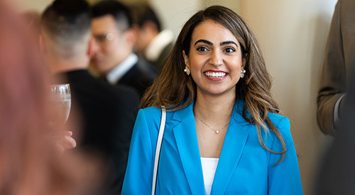 I student smiling at a networking reception