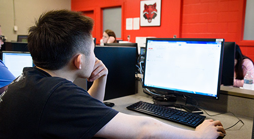 A student working on a computer at A-State